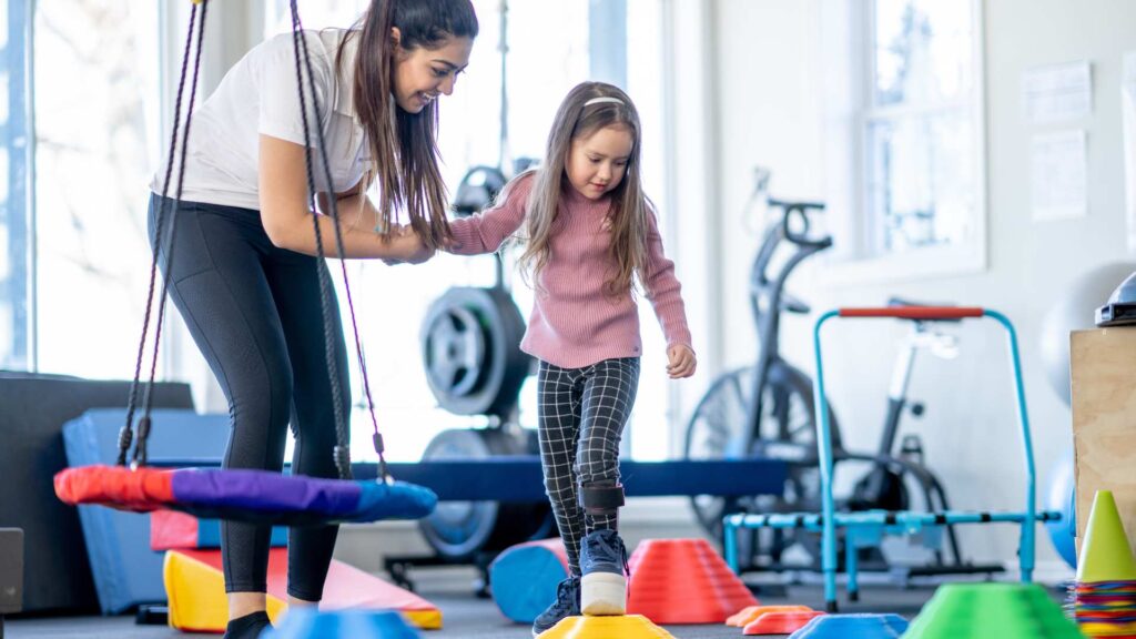 A child in ABA Therapy walking on playful stepping blocks, working in a safety‑focused session to treat autism and elopement behaviors