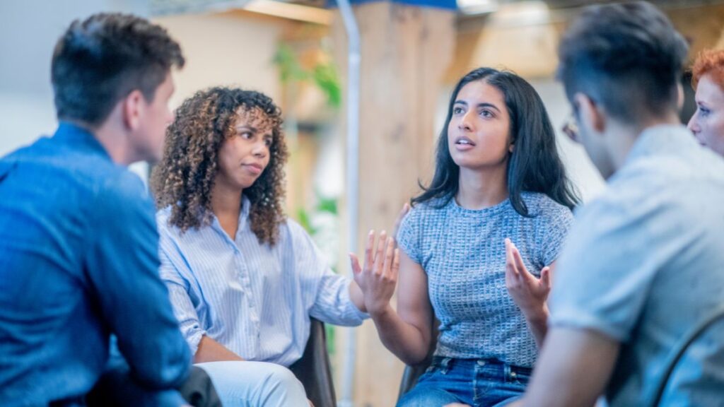 A group of parents discussing autism in a supportive environment.
