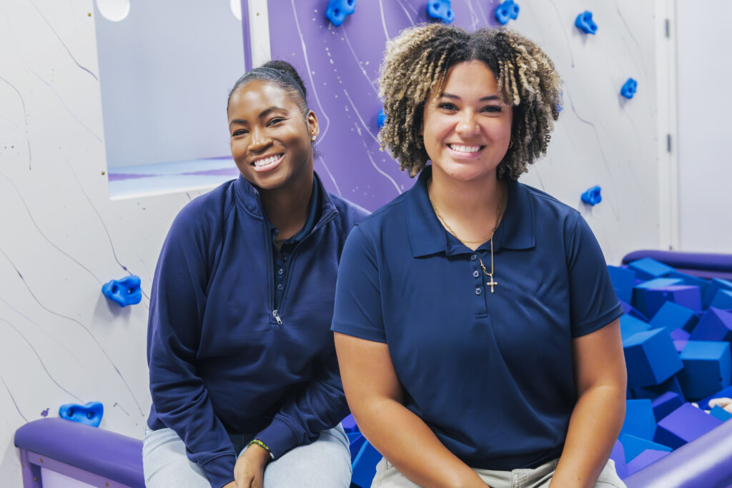 ABA therapy team members smiling in sensory gym