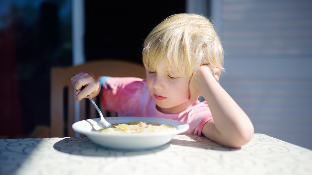 Young child exploring food during mealtime