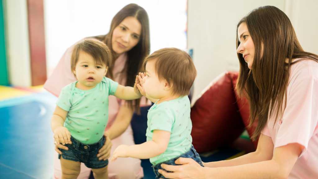 Specialists observing a toddler during an early autism diagnosis screening