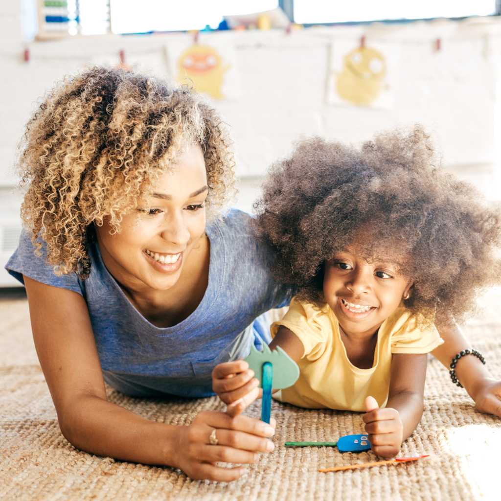 Parent engaging a young child in interactive play to support early autism diagnosis and developmental monitoring