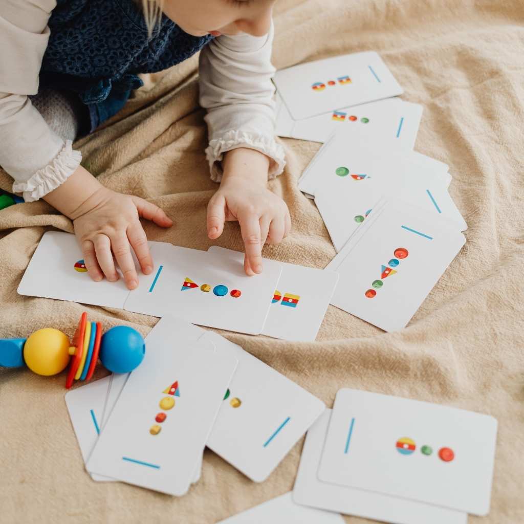 Toddler matching picture cards during an ABA learning activity
